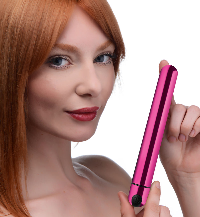 Pink metallic slim Bang! bullet held up by a model to show its length