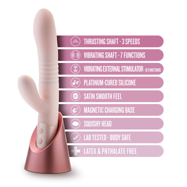 Blush Fraya in pink: thrusting rabbit vibrator on a rose gold magnetic charging stand. Platinum-cured silicone, squishy head