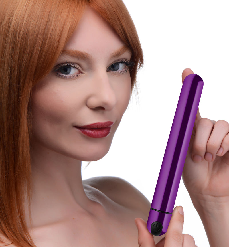 Bang! metallic slim bullet vibrator in shiny purple, long and slim, held up by a model