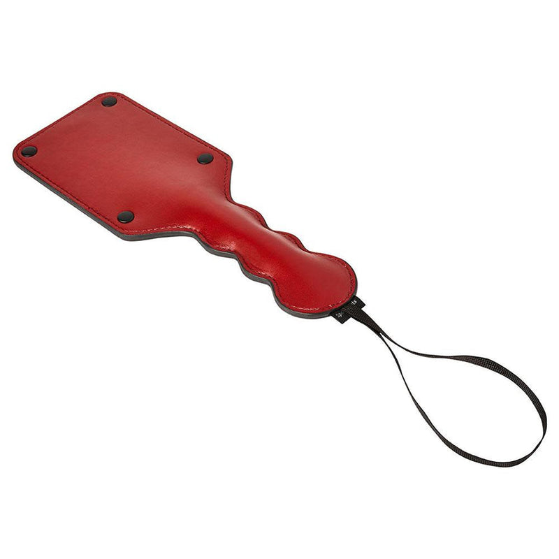 Sportsheets Saffron Square Paddle: red vegan leather square paddle with a wavy grip and black wrist strap