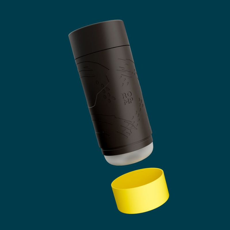 Romp Dash: black manual masturbator cup with an embossed pattern, yellow end cap removed