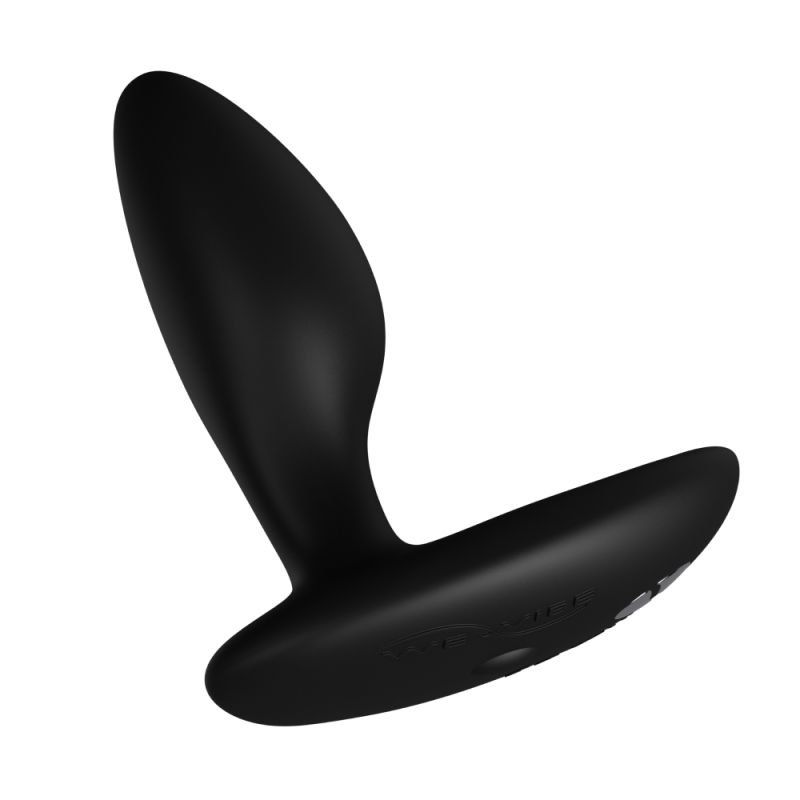 We-Vibe Ditto+: black vibrating anal plug with a tapered head and a curved flat base, angled view