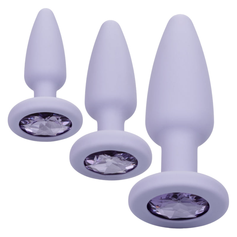 CalExotics First Time Crystal Booty Kit in purple: three silicone anal plugs in graduated sizes with purple gem bases