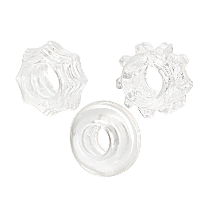 CalExotics Reversible Ring Set in clear: three stretchy cock rings, two star-shaped with nubs and one smooth donut ring