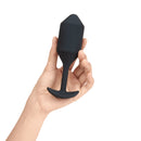 Black Vibrating Snug Plug 4 held in one hand to show its size