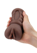 Brown Zolo Diva stroker held in one hand to show its size and the entry