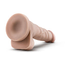 Beige Dr. Skin 7 in dildo lying on its side with the suction cup base raised