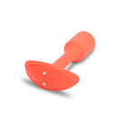 Close-up of the orange Vibrating Snug Plug base with the power button and charging contacts
