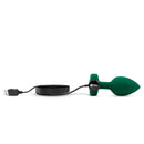 Emerald Jewel Plug charging through its magnetic USB cable on the base