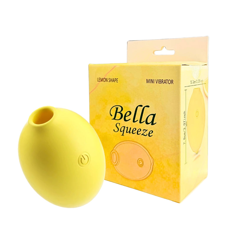 Bella Squeeze in yellow: lemon-shaped mini clitoral vibrator with one button, beside its yellow box