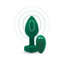 Emerald Jewel Plug standing beside its green b-Vibe remote, with vibration rings drawn around the tip
