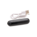 Black metallic Bang! bullet with its white USB charging cable