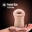 Pocket size: Nicole vibrating stroker held on an open palm, 5.25 inches