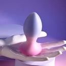 Paradise Plug standing on the palm of a white display hand