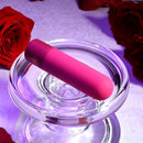 Pink Tiny Temptation resting across a clear glass dish