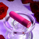 Tiny Temptation on a glass dish, angled to show the button on its base