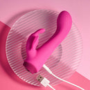 Pink Butterfly Love with its USB charging cable plugged into the base