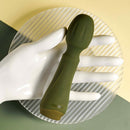 Olive green Heartfelt resting on a white display hand to show its size