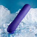 Purple Ambition thrusting vibrator at an angle among ice, showing the smooth rounded base