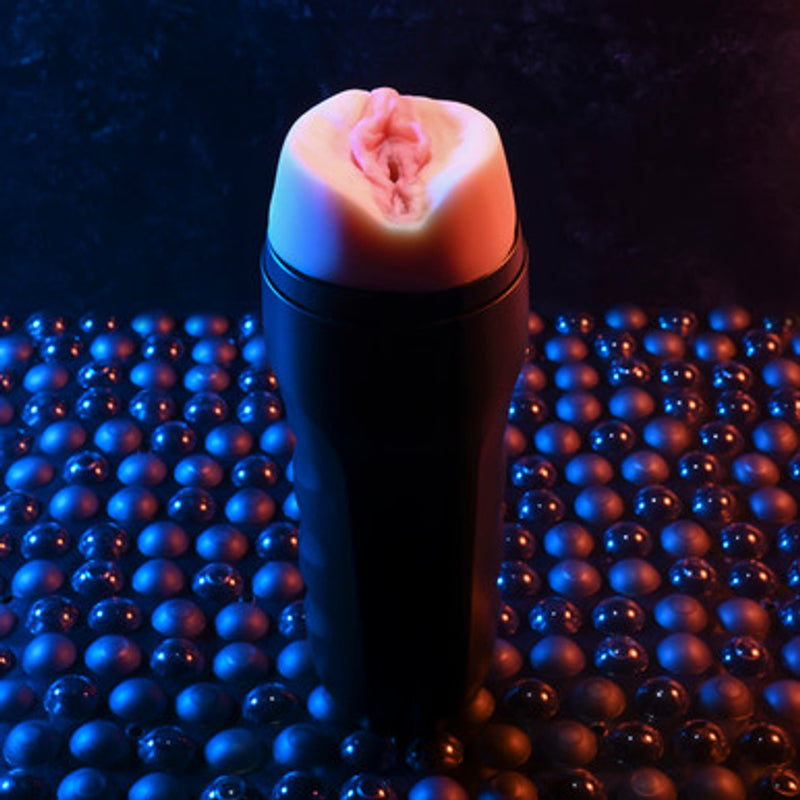 Evolved Grip It in light skin tone: realistic vagina stroker in a black squeezable canister