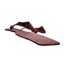 Scandal Paddle lying flat from the other end, showing the brocade side and handle loop