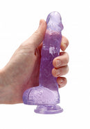 Purple 6 inch dildo held in one hand to show its size