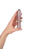 Rose gold Bougie Bullet held in one hand to show its size