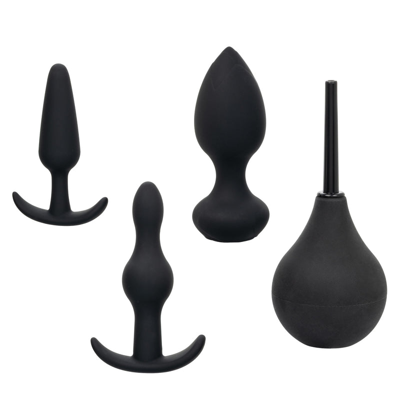 CalExotics Pleasure Kits Anal Explorer Collection: black silicone anal probe, two anal plugs and a douche bulb
