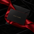 Black gift card with a crimson edge and gold foil lettering on a black envelope and crimson satin ribbon